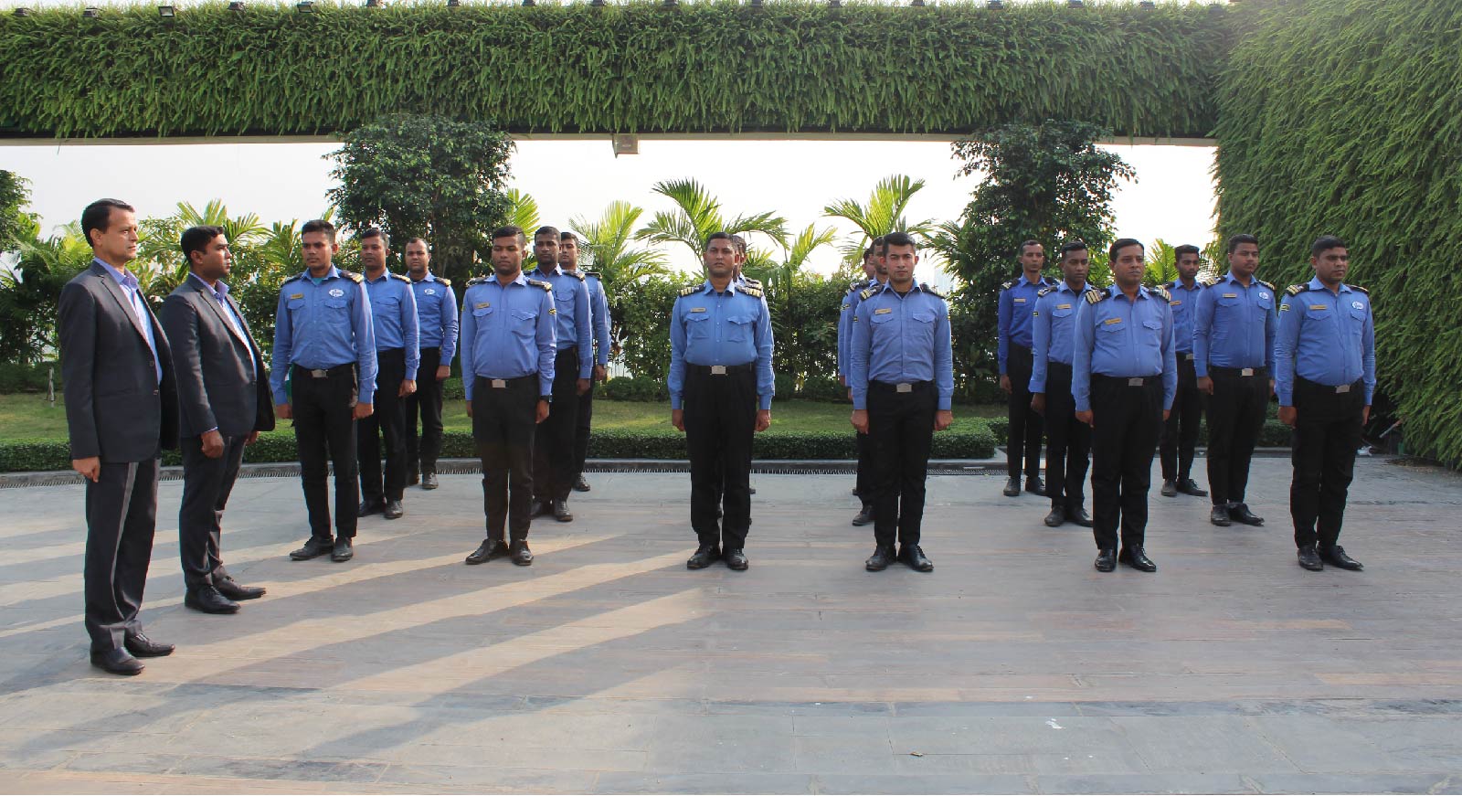HANSA security guards in uniform lined up for inspection by two managers